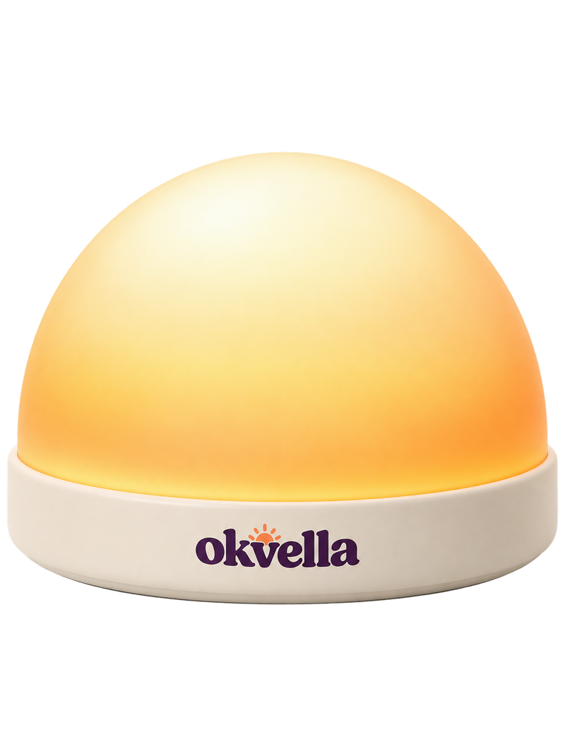 okvella sunrise wake-up light with frosted dome glowing amber on a cream base