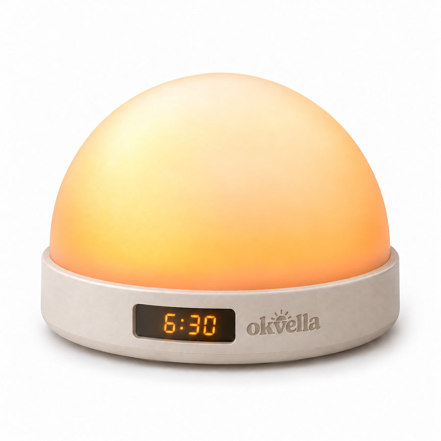 okvella Sunrise Wake-Up Light & Sound glowing warm amber, clock window showing 6:30